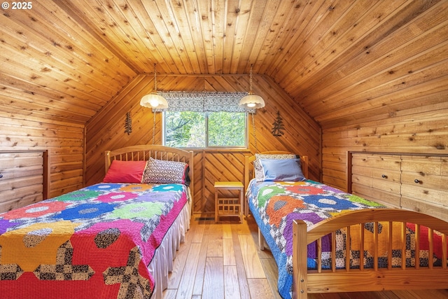 bedroom with wooden walls, lofted ceiling, light wood finished floors, and wooden ceiling