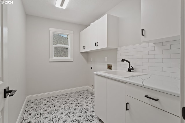 laundry room with light tile patterned flooring, sink, cabinets, hookup for a washing machine, and electric dryer hookup