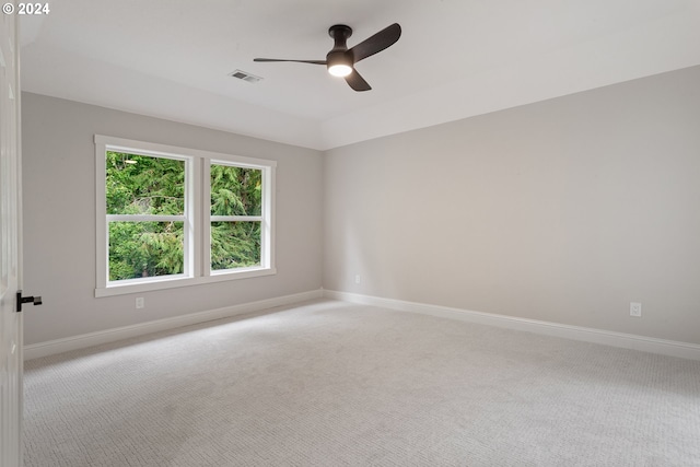 unfurnished room with ceiling fan and light colored carpet