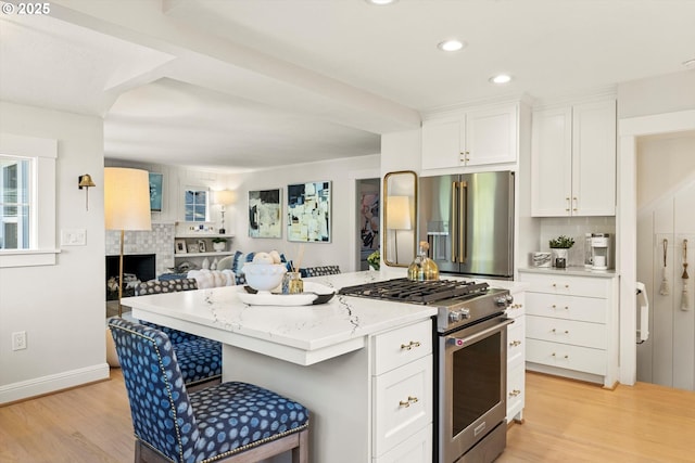 364 Northshore Rd, Lake Oswego, OR 97034 - kitchen with stainless steel appliances, light wood-style floors, white cabinets, a kitchen island, and recessed lighting