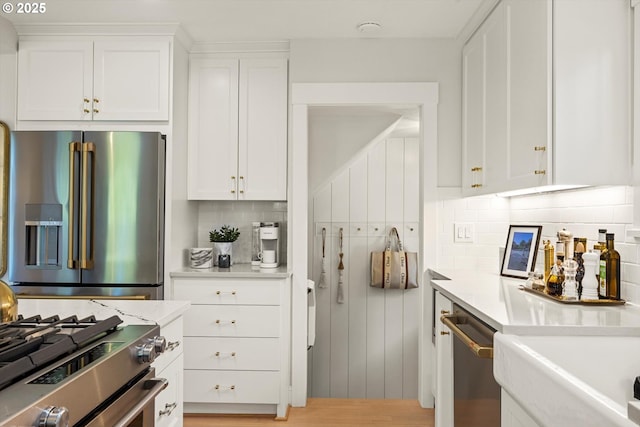 364 Northshore Rd, Lake Oswego, OR 97034 - kitchen featuring appliances with stainless steel finishes, light countertops, backsplash, and white cabinetry