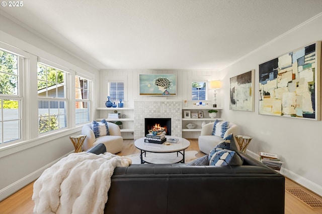 364 Northshore Rd, Lake Oswego, OR 97034 - living room with healthy amount of natural light, a fireplace, wood finished floors, and crown molding