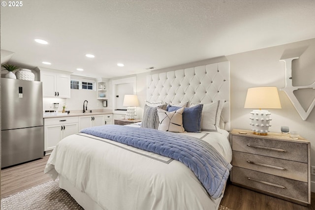 364 Northshore Rd, Lake Oswego, OR 97034 - bedroom with freestanding refrigerator, light wood-style flooring, and recessed lighting