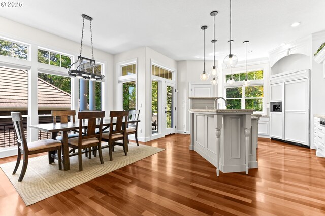 17488 SW Hoodoo Ct, Beaverton, OR 97007 - kitchen featuring paneled refrigerator, dark wood-style floors, an island with sink, recessed lighting, and white cabinetry