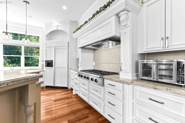 17488 SW Hoodoo Ct, Beaverton, OR 97007 - kitchen featuring stainless steel gas stovetop, paneled built in refrigerator, tasteful backsplash, wood finished floors, and white cabinets