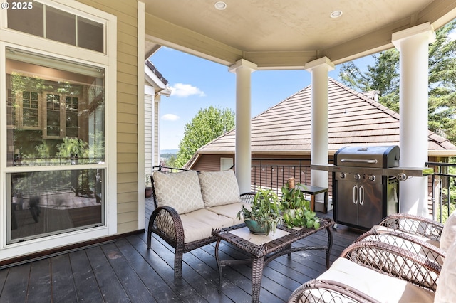 wooden deck with a grill and outdoor lounge area