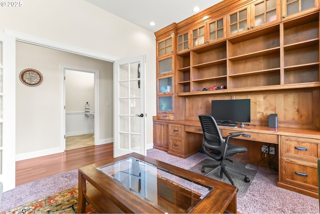 office area featuring built in study area, french doors, baseboards, recessed lighting, and wood finished floors