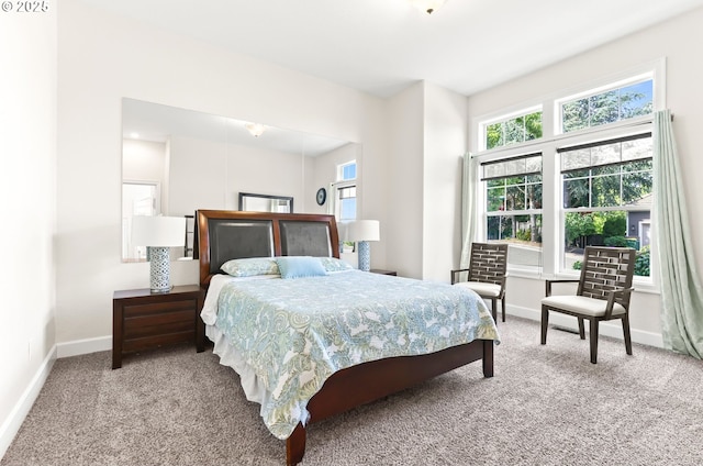 carpeted bedroom featuring baseboards
