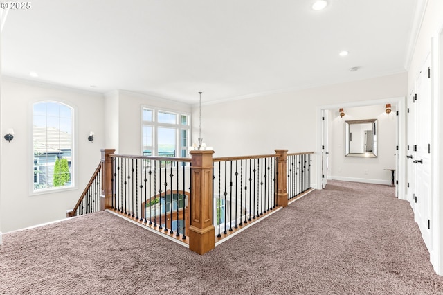 hall featuring carpet flooring, healthy amount of natural light, crown molding, baseboards, and recessed lighting