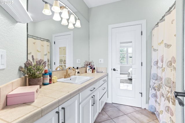 full bathroom featuring vanity and tile patterned flooring