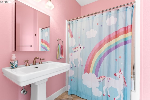 bathroom featuring a sink, tile patterned flooring, and a shower with shower curtain