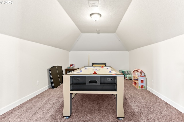 recreation room featuring carpet, vaulted ceiling, and baseboards