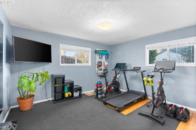 exercise area featuring a textured ceiling