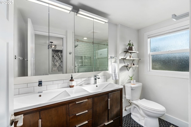 bathroom featuring vanity, toilet, a shower with shower door, and backsplash