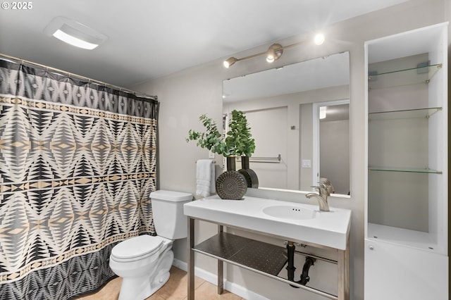 bathroom featuring sink, tile patterned floors, and toilet