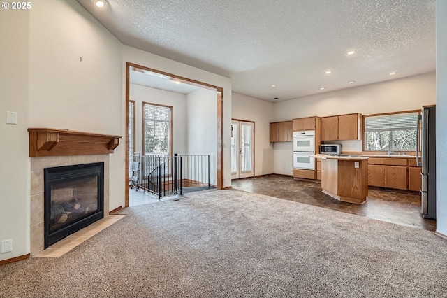 1207 NE 2nd Cir, Battle Ground, WA 98604 - kitchen featuring open floor plan, a wealth of natural light, dark colored carpet, and stainless steel appliances