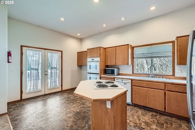 1207 NE 2nd Cir, Battle Ground, WA 98604 - kitchen featuring white appliances, french doors, light countertops, and a sink