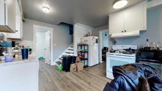 kitchen featuring tasteful backsplash, white appliances, sink, light hardwood / wood-style flooring, and white cabinetry