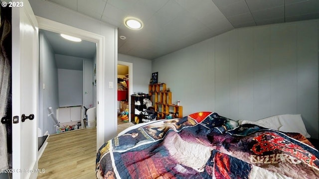 bedroom featuring hardwood / wood-style flooring and lofted ceiling