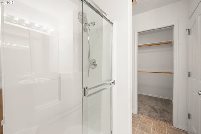 bathroom featuring a shower with door