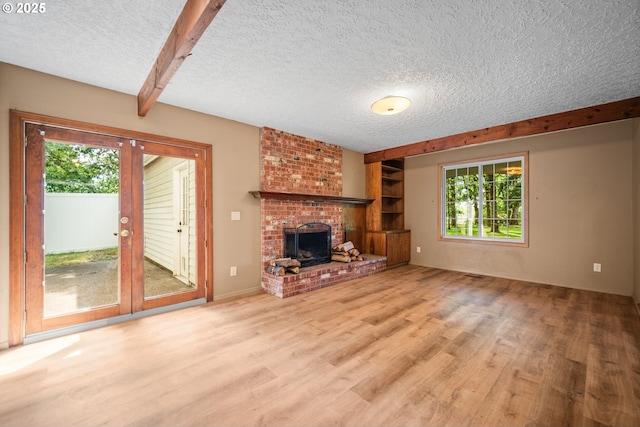 5807 NE 152nd Ave, Vancouver, WA 98682 - unfurnished living room featuring plenty of natural light, wood finished floors, a textured ceiling, french doors, and a brick fireplace