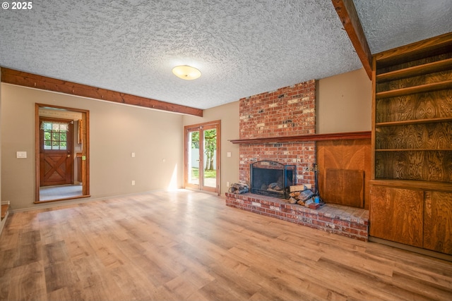 5807 NE 152nd Ave, Vancouver, WA 98682 - unfurnished living room featuring wood finished floors, a fireplace, and a textured ceiling