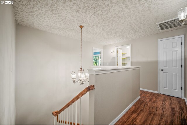 5807 NE 152nd Ave, Vancouver, WA 98682 - hall with an upstairs landing, dark wood-type flooring, a textured ceiling, and a chandelier