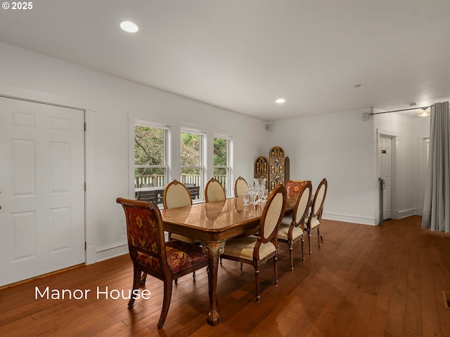 dining area featuring recessed lighting, baseboards, and wood-type flooring