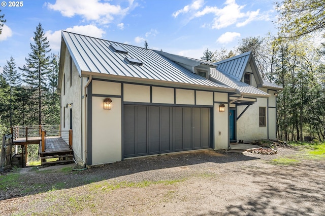 827 Tyler Creek Rd, Ashland, OR 97520 - view of front facade with a standing seam roof, a metal roof, stucco siding, and a garage