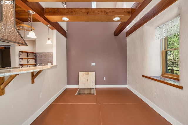 827 Tyler Creek Rd, Ashland, OR 97520 - kitchen featuring tile patterned flooring, beamed ceiling, decorative light fixtures, and light stone counters