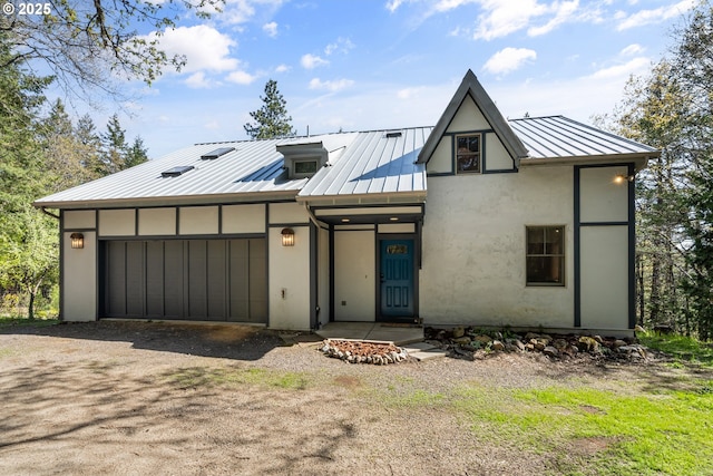 827 Tyler Creek Rd, Ashland, OR 97520 - view of front facade featuring a standing seam roof, stucco siding, a garage, a metal roof, and dirt driveway