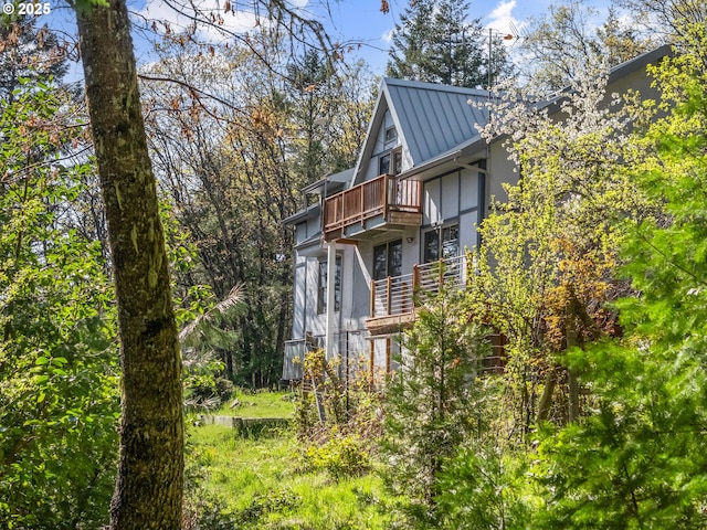 827 Tyler Creek Rd, Ashland, OR 97520 - view of property exterior with a balcony, a metal roof, a standing seam roof, and stucco siding