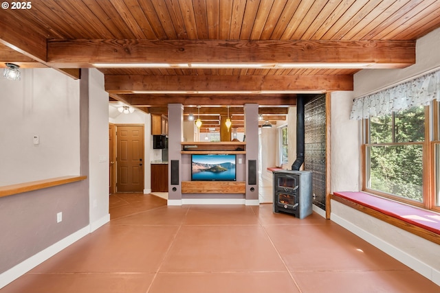 827 Tyler Creek Rd, Ashland, OR 97520 - unfurnished living room with a wooden ceiling with exposed beams, a wood stove, and tile patterned floors