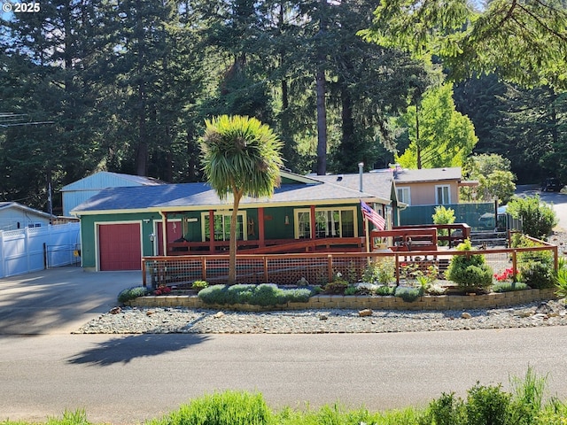 2420 Jefferson St, Port Orford, OR 97465 - ranch-style home with an attached garage, concrete driveway, and covered porch