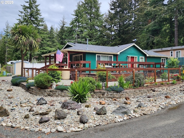 2420 Jefferson St, Port Orford, OR 97465 - ranch-style home with a deck, an outbuilding, and roof with shingles