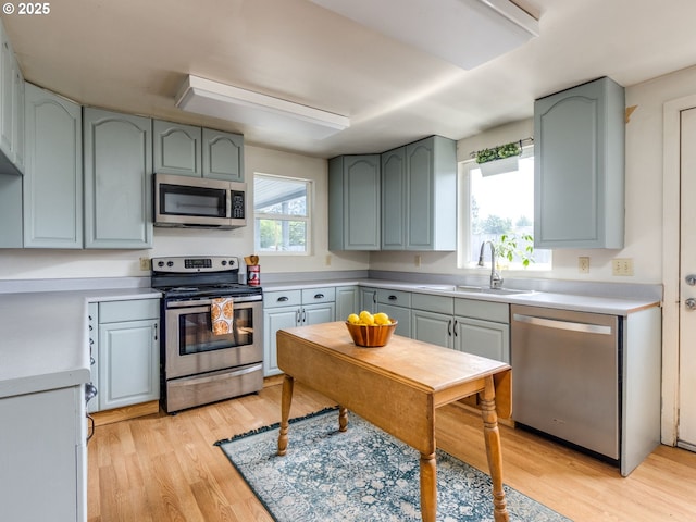 486 S Knott St, Canby, OR 97013 - kitchen with appliances with stainless steel finishes, light wood-style floors, and light countertops
