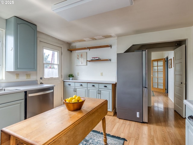 486 S Knott St, Canby, OR 97013 - kitchen featuring stainless steel appliances, light wood finished floors, light countertops, and open shelves