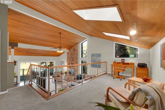 interior space with carpet, wooden ceiling, and a healthy amount of sunlight