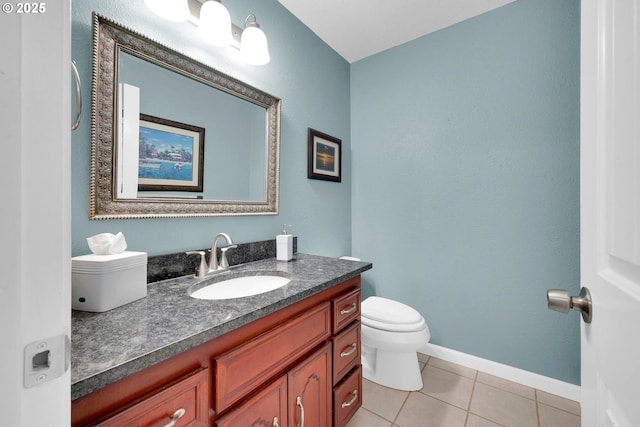 half bath featuring baseboards, vanity, toilet, and tile patterned floors