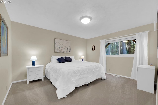 carpeted bedroom with baseboards