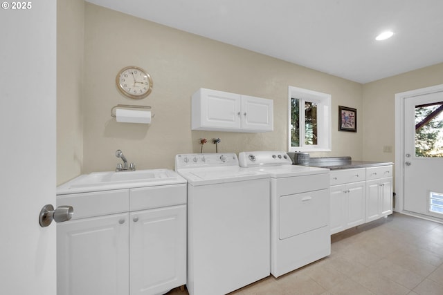 laundry area with cabinet space, a sink, visible vents, and washing machine and clothes dryer