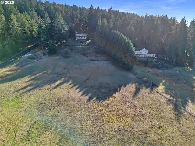 birds eye view of property featuring a wooded view