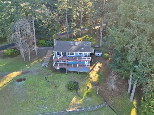 birds eye view of property featuring a view of trees