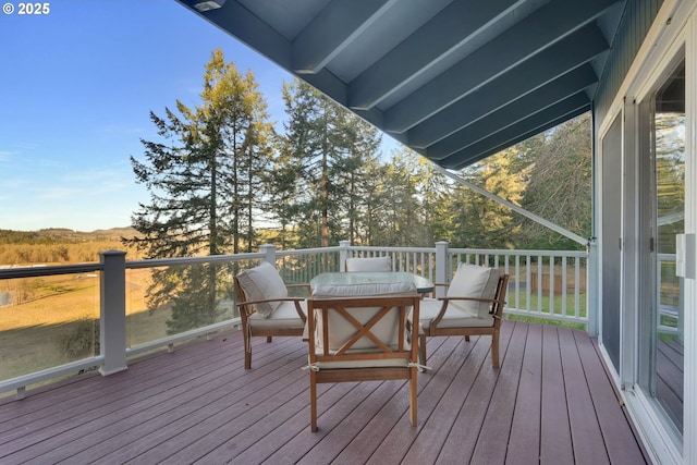 wooden deck featuring outdoor dining area