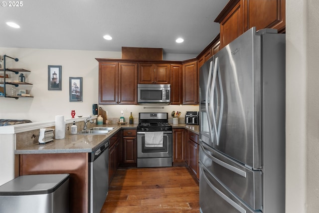 813 NW 1st Ave, Canby, OR 97013 - kitchen featuring appliances with stainless steel finishes, a sink, dark wood-type flooring, a peninsula, and recessed lighting