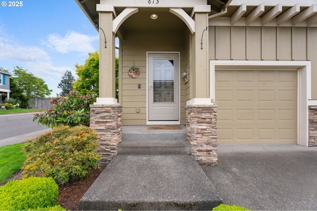 813 NW 1st Ave, Canby, OR 97013 - view of exterior entry with board and batten siding and an attached garage