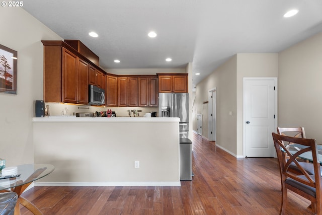 813 NW 1st Ave, Canby, OR 97013 - kitchen featuring appliances with stainless steel finishes, dark wood-type flooring, recessed lighting, a peninsula, and baseboards