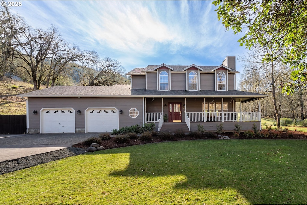 view of front facade with a garage, a front lawn, and a porch