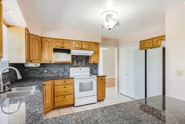 1825 Minnesota St, The Dalles, OR 97058 - kitchen with decorative backsplash, a sink, under cabinet range hood, white appliances, and light tile patterned flooring