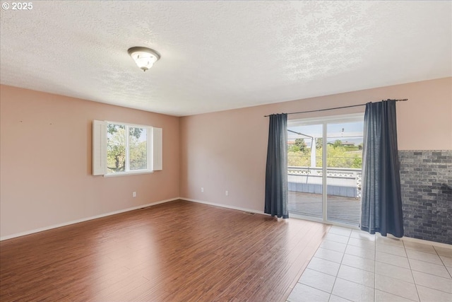1825 Minnesota St, The Dalles, OR 97058 - unfurnished room with a textured ceiling, baseboards, and light wood finished floors
